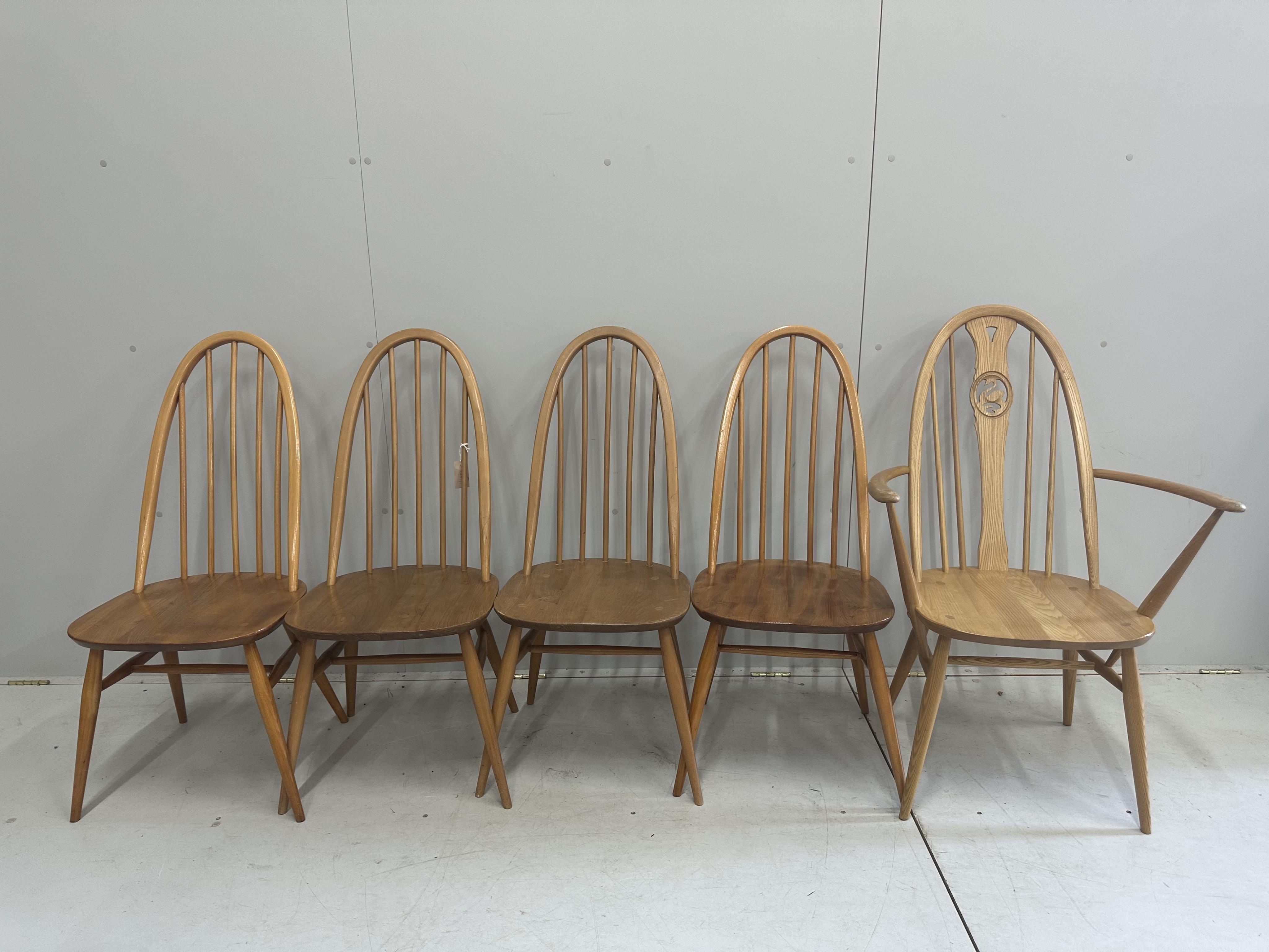 An Ercol elm oval drop leaf dining table, width 124cm extended, height 71cm, together with five Ercol elm, ash and beech dining chairs. Condition - fair to good